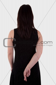 young woman seen from behind, his hands back, her fingers crossed