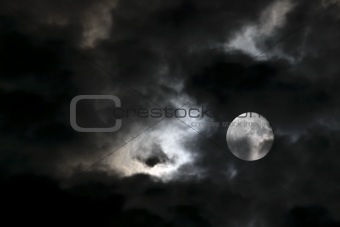 Vortex of eerie white clouds and full moon
