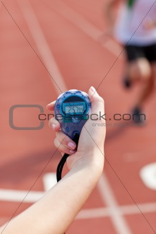 Close-up of a woman holding a chronometer to measure performance