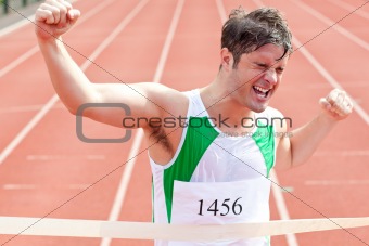 Exulting sprinter showing expression of victory in front of the 