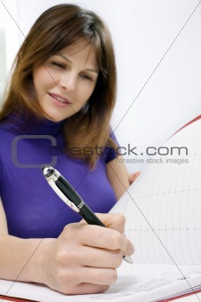 woman working in a medical office with calendar of appointments