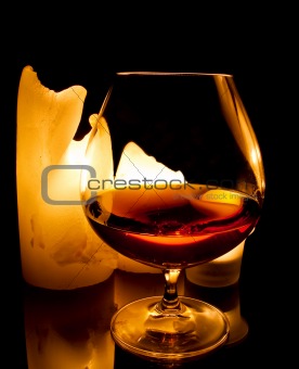 candles and a glass of brandy