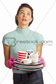 Young beautiful housewife with pile of dirty dishes
