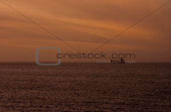 Cargo ship anchored at sunset