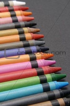 Colorful crayons against black