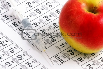 Apple lying on periodic table