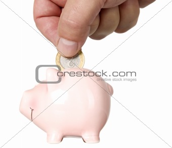 Man is putting money into saving pig