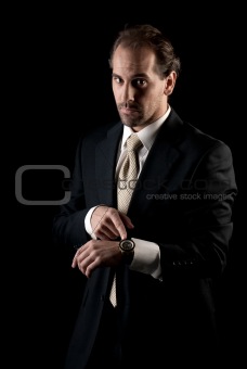 Adult businessman pointing to clock, arrive late deadline concept