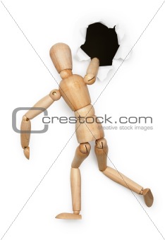 Wooden person tries to climb in hole on white