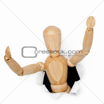 Wooden toy man looks out of hole