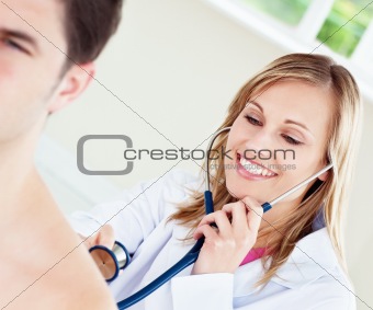 Smiling doctor is examinating her patient