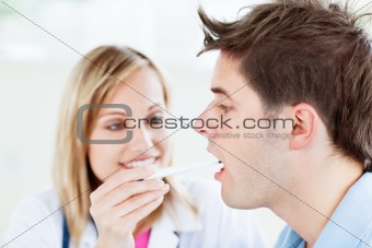 Woman doctor taking the temperature of her patient 