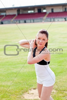 attractive athletic woman during a shot put training in a stadiu