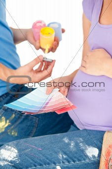 Pregnant woman and her husband choosing samples
