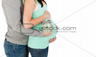 close-up of  future parents holding a clock