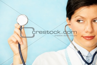 adult caucasian woman as a doctor holding stethoscope