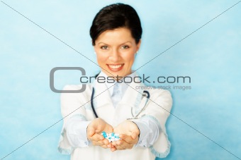 adult caucasian woman as a doctor holding meds