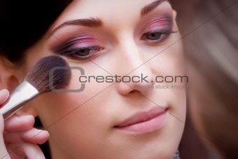 closeup brunette young lady prepared by makeup artist