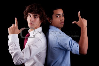 two young man of different colors, back to back, with hand as an police officer with weapon raised, isolated on white, studio shot