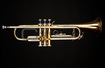 brass trumpet over black background
