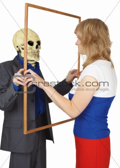 Woman looks at skeleton as reflected