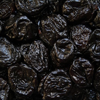 Dry plums or prunes fruit as background 