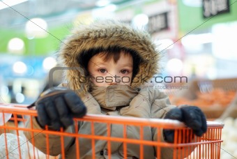 Little boy in shopping cart