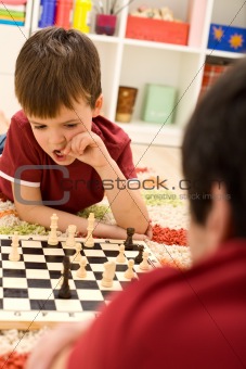 What should I do now - kid playing chess thinking