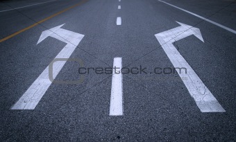 Arrow signs on asphalt