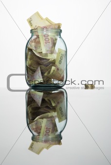 Glass jar full of hundreds of grivnas