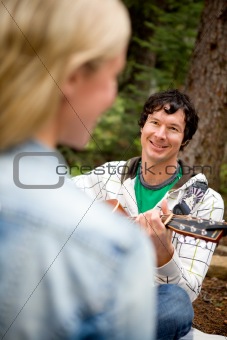 Man Serenading a Woman with Guitar