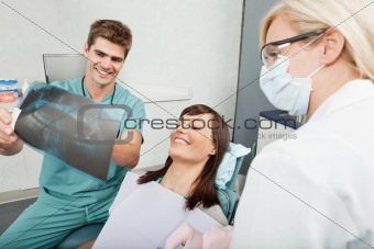 Dentist explaining the details of x-ray to a female patient