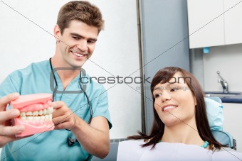 Dentist explains a female patient denture work in clinic