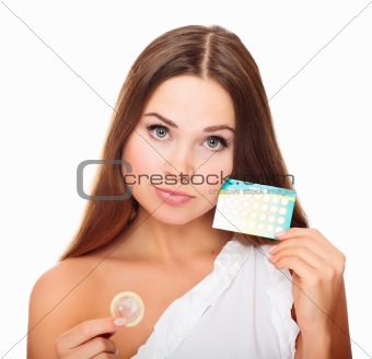 Pretty girl with condom and contraceptive pills 