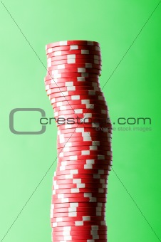 Stack of red casino chips against green background