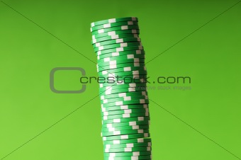 Stack of casino chips against green background