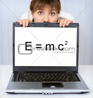 Woman shows computer screen with formula