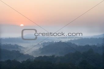 sun rise above a fog and mountain