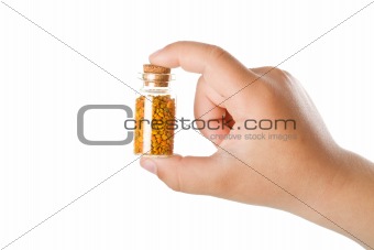 Small bottle with pollen in child hand
