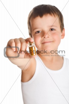 Little boy holding bottle with pollen - isolated
