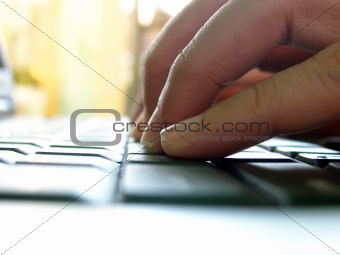 Fingers typing on computer keyboard