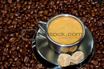 cup of coffee in a pile of coffee beans