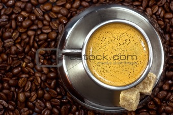 cup of coffee in a pile of coffee beans