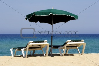 sun lounger on sandy beach, corsica, mediterranean