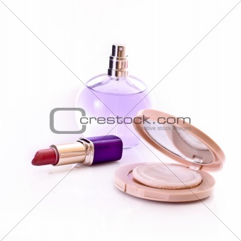 Lipstick, powder and perfume isolated on white