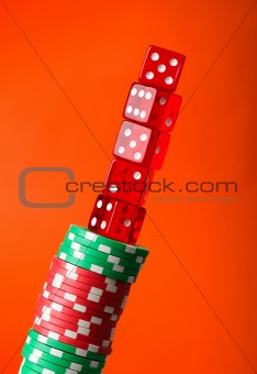 Casino chips and cards against red background