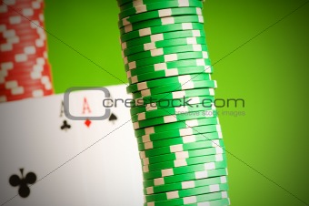Casino chips and four aces against green background