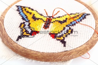 Butterfly embroidered on embroidery hoop