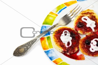 Cottage cheese pancakes on a colorful plate with fork