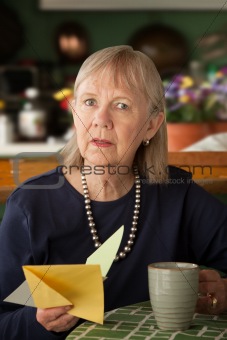 Senior woman with sympathy card